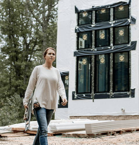 female builder or remodeler working on a window job site